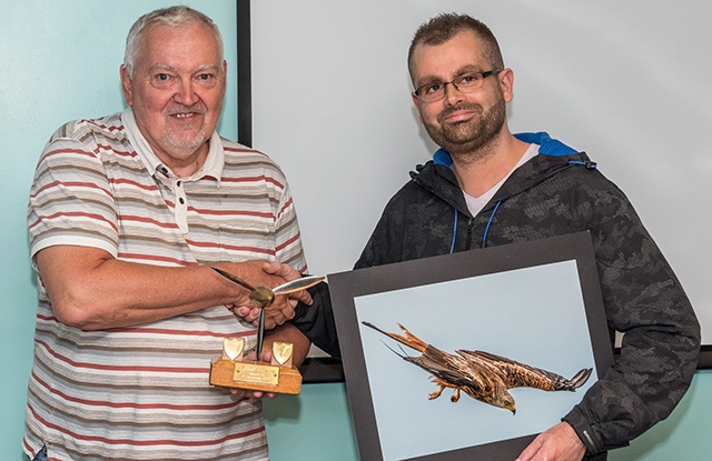 Oldham Camera Club chairman Phil Livesey presents the silverware to Martyn Brophy