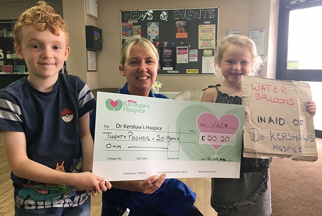 Harley Vickers and his friend Lily Coffey present a cheque to Dr Kershaw's Hospice