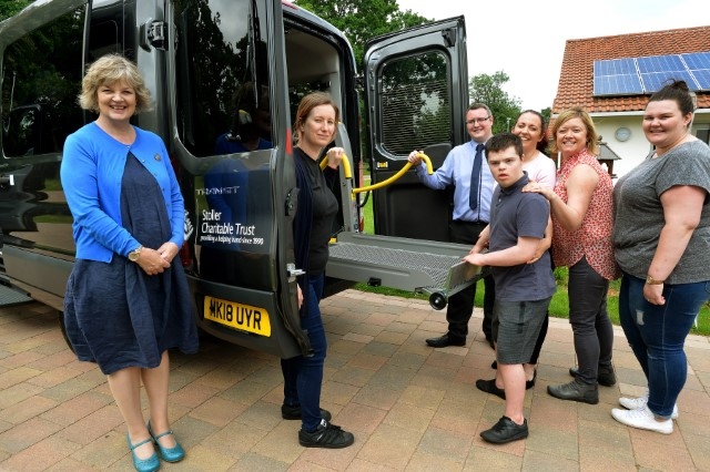 Fifteen-year-old Seashell Trust student Vincent Parkinson accepts delivery of Seashell Trust’s new minibus on behalf of the charity. He is pictured with members of the Care team