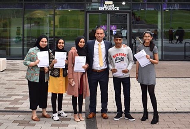 Oldham Academy North Headteacher Chris Davis with the school's top five achievers