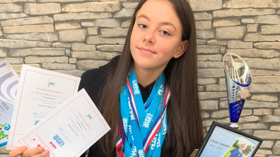 Tilly with her medals and awards