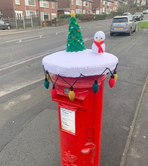 Who placed the festive mantel on the post box appears to be a mystery.