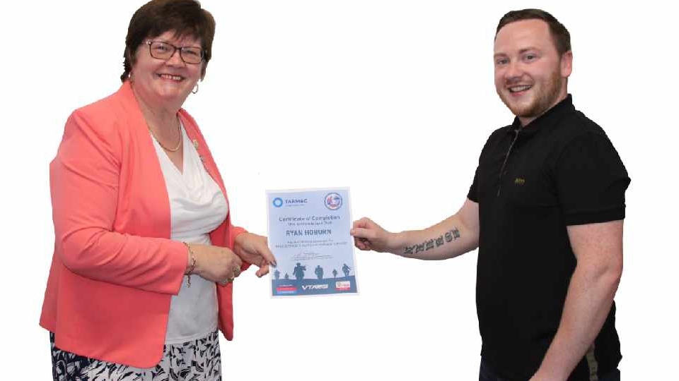 Ex-Royal Artillery veteran Ryan, from Oldham, is presented with his certificate by Rochdale Councillor Janet Emsley