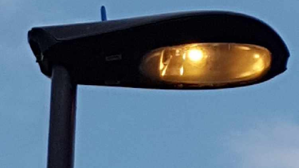 A streetlight burns energy during the daytime