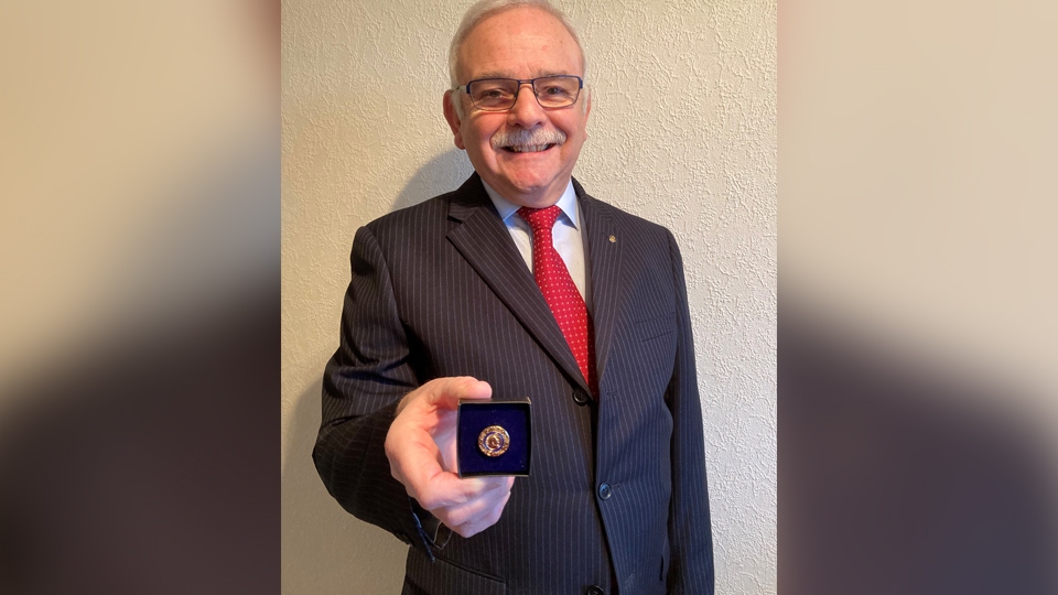 Garvin Crabtree, Oldham Metro Rotary president, with the Paul Harris award