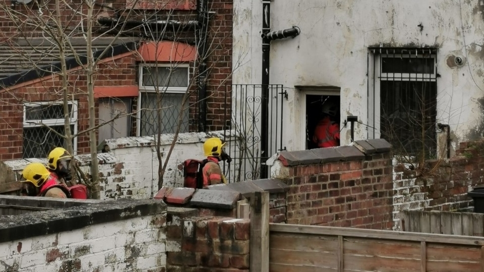 Firemen can be seen attending the property on Hollins Road yesterday