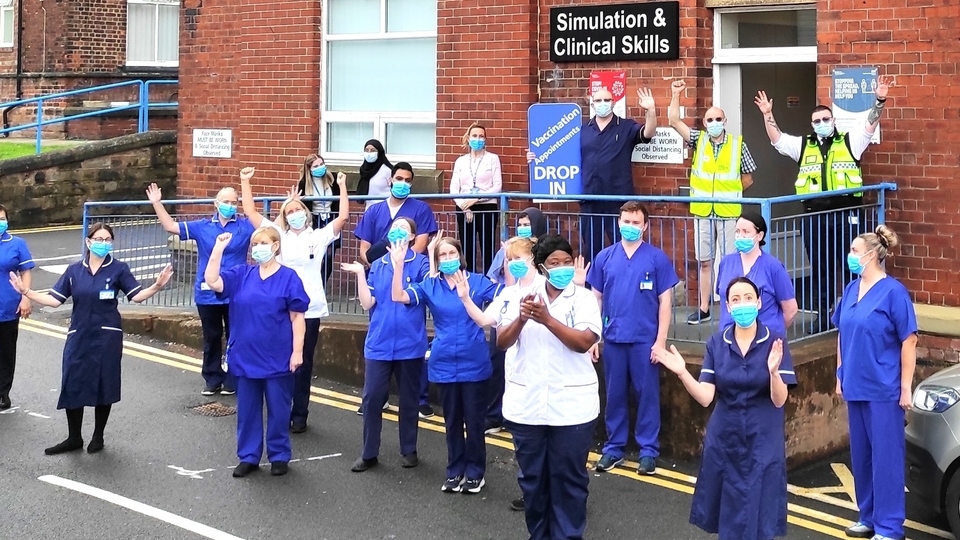 Royal Oldham Hospital staff celebrating a COVID vaccination milestone