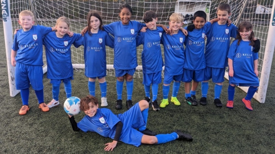 The football team at Royton Hall Primary School show off their new kits