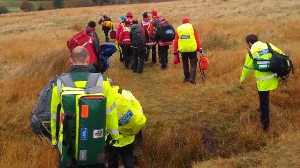 The walker being escorted to a waiting ambulance