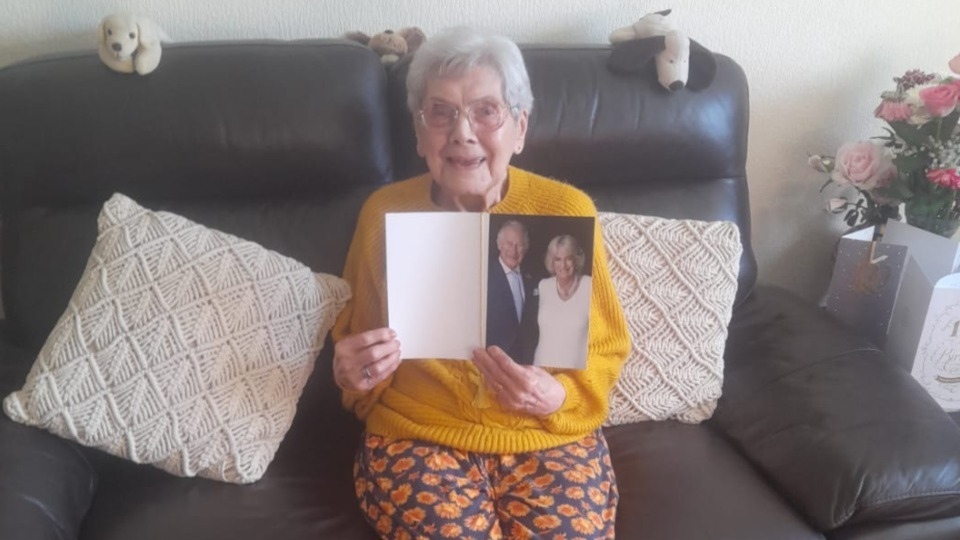 Mary with her treasured card from King Charles III and Camilla, the Queen Consort