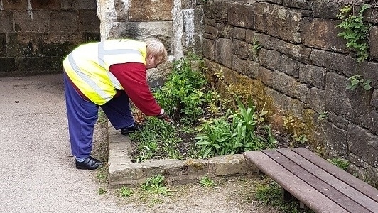 Uppermill Community Action Network (UCAN) volunteer tending to the flower beds