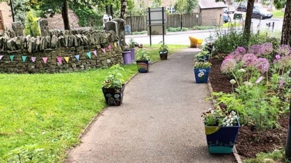 The village’s community garden featured pots decorated by school children containing sunflowers they had grown from seed