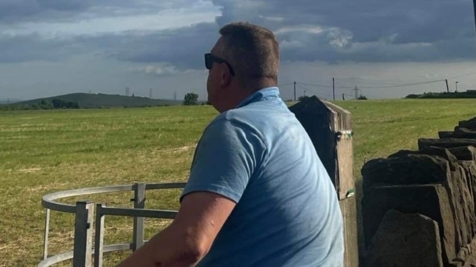 John Collins surveys his farmland at Doctor Lane in Scouthead