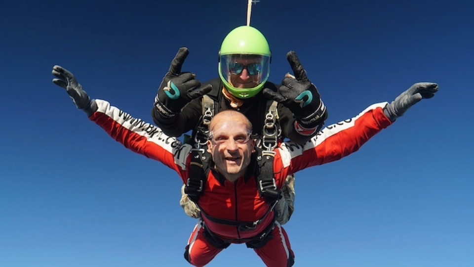 Dan Mounsey is pictured flying high with his parachute partner!