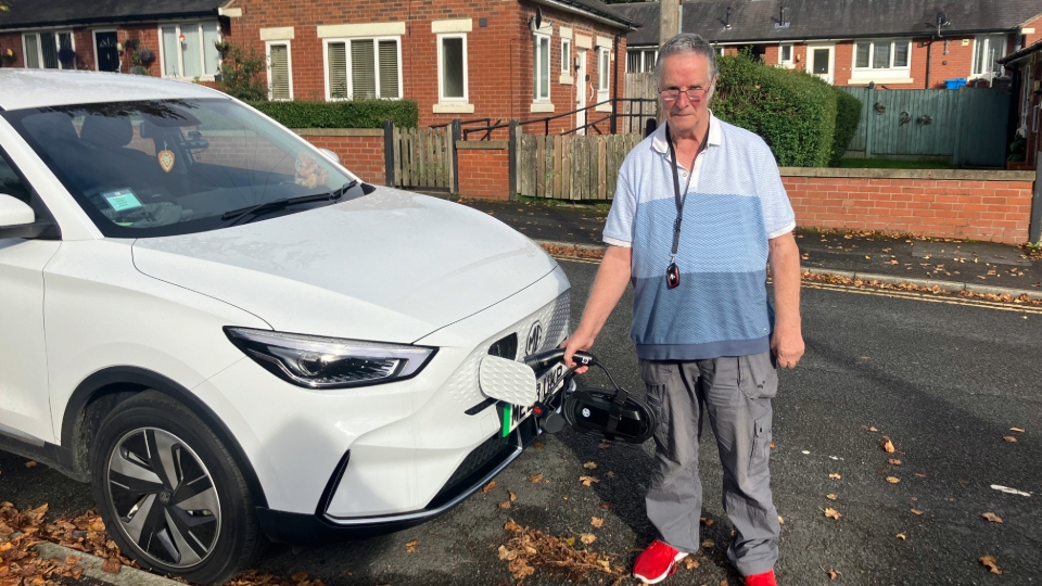 David Kelsall is pictured next to his EV. Image courtesy of Charlotte Hall 