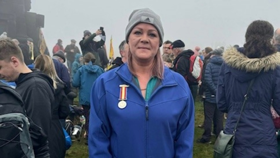 Julie Bradbury pictured with her father's cherished medal