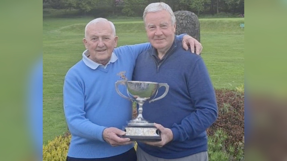 Local golf legends Les Lawton and Alan Squires with the District Scratch Championship trophy