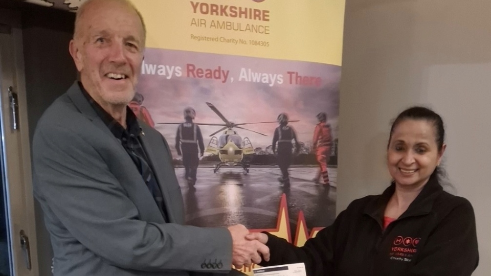 Saddleworth Rotary Club President Clint Elliott presents Angela Vyas from Yorkshire Air Ambulance with a cheque for £500 donation to the charity