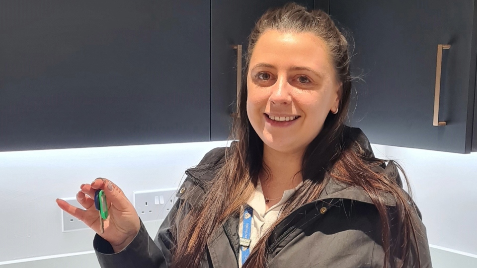 Charlotte Satchell-Higgins is pictured with her new home key