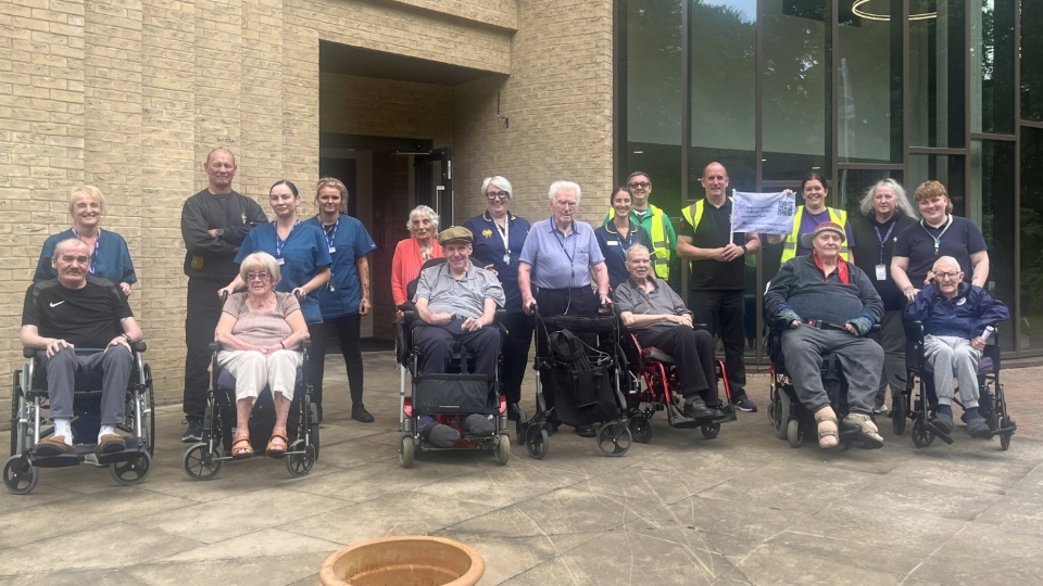 Sarah Tate, back row, third right, and fellow walkers at Broughton House, with staff and residents