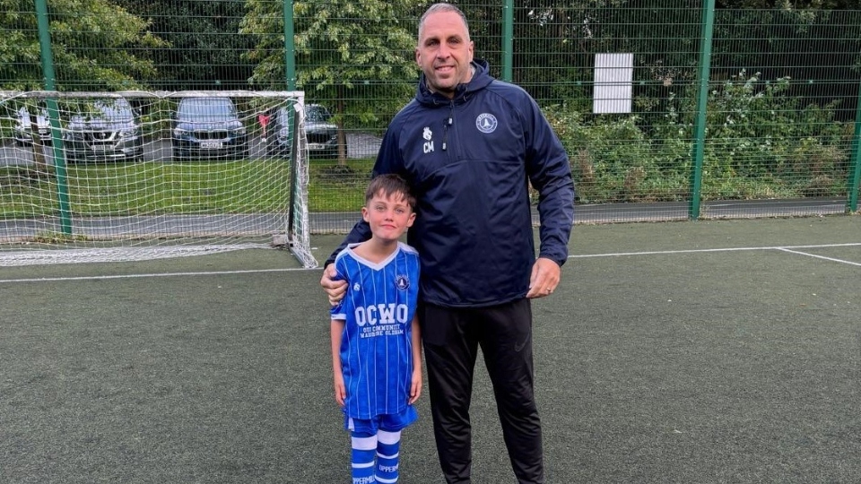 Coach Chris Morris is pictured with his son and Uppermill FC under-eights player, Iestyn