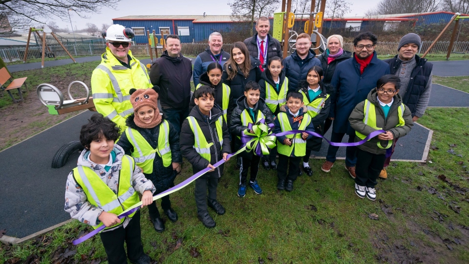 Mill Town Park is officially opened by pupils from Richmond Academy. Pictured from left, back row, are: Pat Farnan, Caddick Construction; Jamie Smith, FCHO; David Wrigley, FCHO; Charlotte Smythe, Richmond Academy; Andy Ewart, FCHO; Michael Webb, FCHO; Louise Bolton, Richmond Academy; Councillor Abdul Jabbar and Councillor Abdul Malik. Along the front row are pupils from Richmond Academy