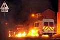 police vans drive through flames in the early hours as gangs of youths hurled petrol bombs at officers and erected burning barricades on the riots’ second night 
