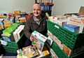 STOCKING up: Oldham Foodbank manager Andrew Barr boxes up donated goods 

