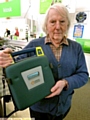 POTENTIAL lifesaver: Councillor Alan Roughley with a defibrillator unit 
