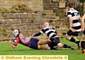 Jason Green plunges over the line for a try.