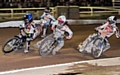 SO CLOSE: Aces’ Craig Cook (blue helmet) leads Poole’s Dakota North (white) in a nail-biting Elite League Grand Final clash. 