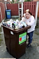 Pamela Kay - with overflowing recycling bin