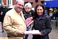 SIGNING the petition . . . Ken Rustidge with his son, Alexander, aged three, and Mrs Abrahams