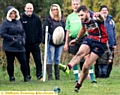 WATCHING OVER YOU: Jamie Mayall kicks for goal. 