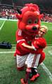 MATCH mascot . . . Riley Parrish with Fred the Red before the game