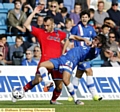 Luke Kelly battles for possession with Bradley Dack.
