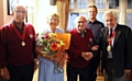 CONGRATULATIONS: Joe, centre, and his wife Doreen with choir president Malcolm Hill, right, and watched by other choir members