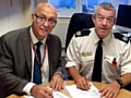 Dr Ian Wilkinson, Chief Clinical Officer for NHS Oldham CCG, and Ian Bailey sign the partnership agreement.