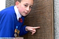 Shaw Remembrance Sunday. Leo Baker, house captain at Crompton primary school, points to his Great Great Grandfathers name , J.F. Tetlow, who fell at the Battle of the Somme, during the Great War. 