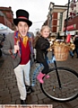 THAT’S magic! Festive Foxley, performed tricks for the shoppers and Madison Taylor, aged six, gets a lift on his bike
