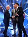 WHAT AN HONOUR: Kevin Sinfield (right) shakes hands with Irish boxing legend Barry McGuigan after receiving his BBC runner-up trophy.