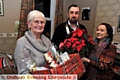 CHRISTMAS gifts . . . Marlene Horton receives her hamper from Saddleworth Round Table chairman Matthew Skyes and neighbour Jackie Warburton
