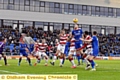 striker Jake Cassidy gets up best to win a header.