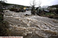 SEVERE torrent . . . the River Tame bursts its banks near Holland Close, Delph. 