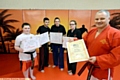 PROUD SMILES . . . DEMAA Martial Arts instructor Dave Terry (right) is pictured with (from left): Chelsea Hoy (first dan), Sohail Mahmood (second dan), Amy Sutcliffe (first dan) and Lucy Haslam (second dan).
