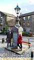 BACK to its best . . . Dobcross Village Community chair Pamela Rose with vice chair Paul Clegg at the restored memorial. 