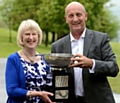 Eileen Simpson receives the cup from the Chronicle's David Whaley