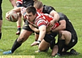 ACTION STATIONS: Oldham’s Phil Joy tries desperately to get to the Gloucester try-line. 