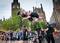 PROUD: Olympic hero Henry Taylor “swims” past Manchester Town Hall. The gold medallist was the focus of Oldham’s contribution to the Manchester Day parade
