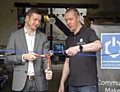 COUNCIL leader Jim McMahon is given bolt-cutters to break the chain at the official opening of geek haven Hack Oldham. He is pictured with founder Andy Powell. 
